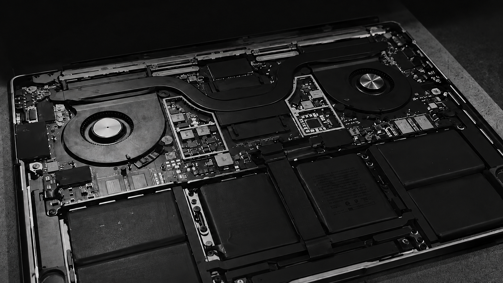 Board-level access — logic board, cooling and battery bays opened for diagnosis
